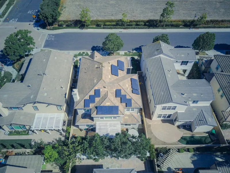 Happy family in front of their residential solar home in California — Superior Solar installation